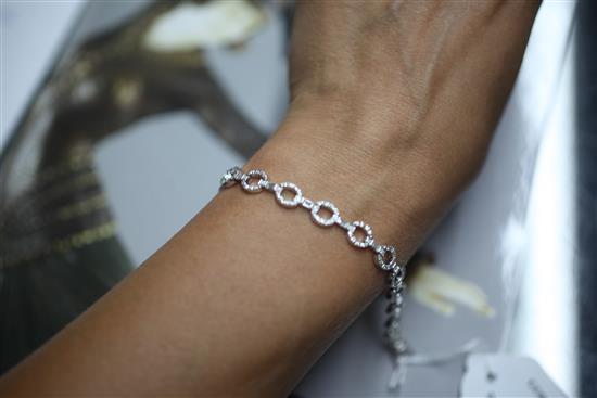 A modern 18ct white gold and round and baguette cut diamond set open work bracelet, approx. 18cm.